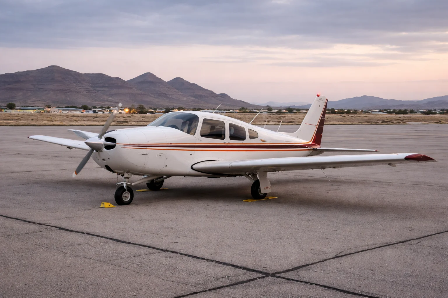 Single-engine piston aircraft on an airport ramp at a desert municipal airport