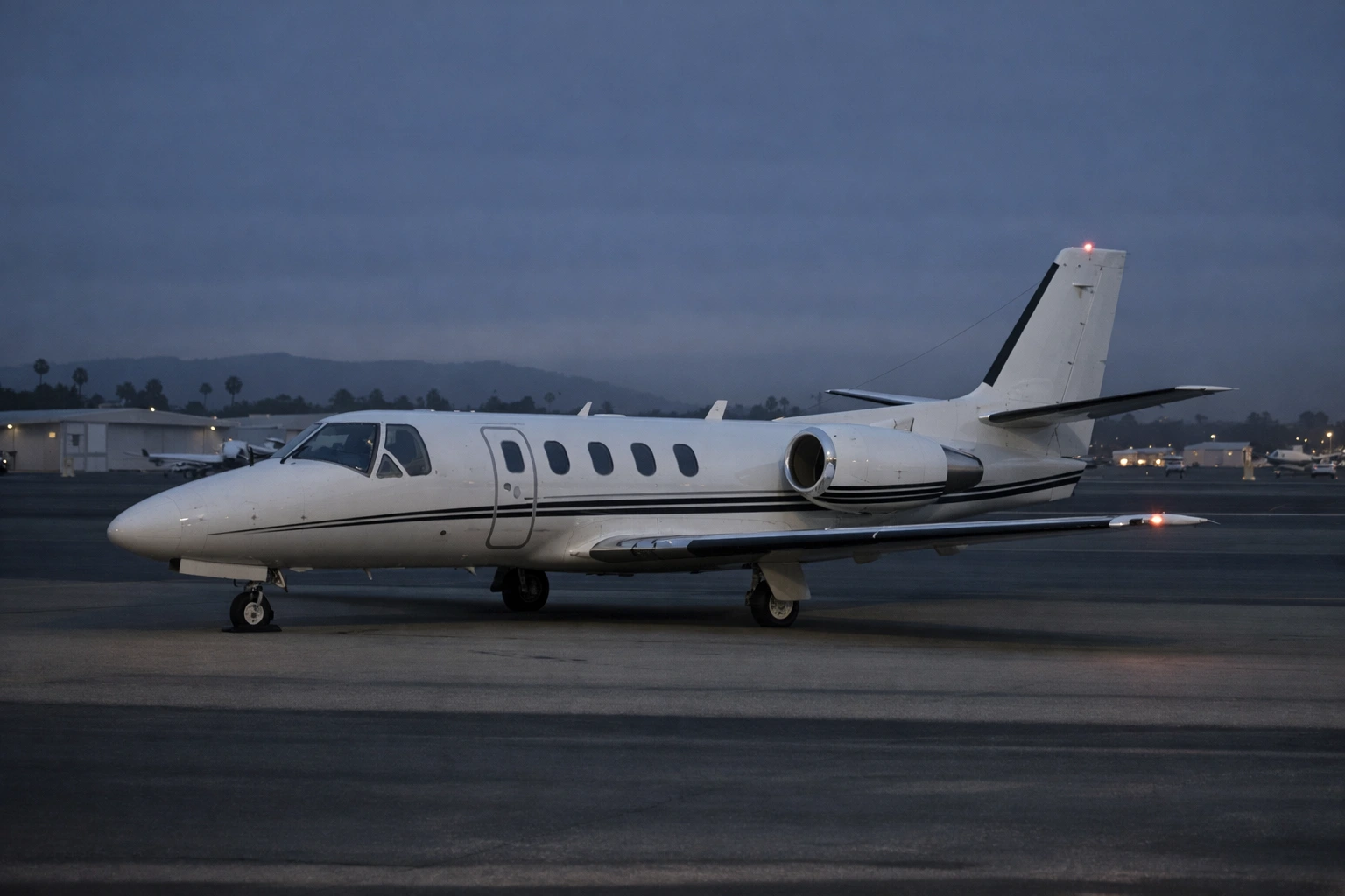 Cessna Citation S550 business jet on an executive airport ramp in a night-to-dawn setting